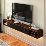 dark wood floating tv shelf with black cabinet panel