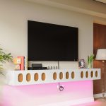 Glossy white wall-mounted TV cabinet with wood-patterned cut-out doors and cable management