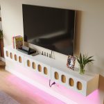 High-gloss white media cabinet mounted on wall with stylish woodgrain accents and clean lines