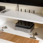 Minimalist floating white TV cabinet in high-gloss finish with organized media storage