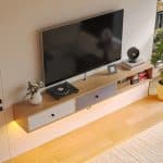 Scandinavian-style-floating-TV-cabinet-with-white-and-gray-drop-down-doors-and-cable-management-scaled