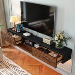 Wall-mounted narrow TV stand featuring drop-down center cabinet and drawers