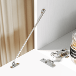 A white contemporary TV stand placed in a sunny living room, matching well with the light-colored walls and floor.