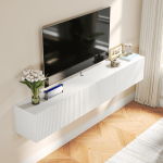 a long contemporary TV stand with white flowers and a picture frame on the side.