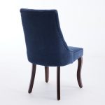 Blue upholstered dining chair with vertical stitched backrest and wooden legs