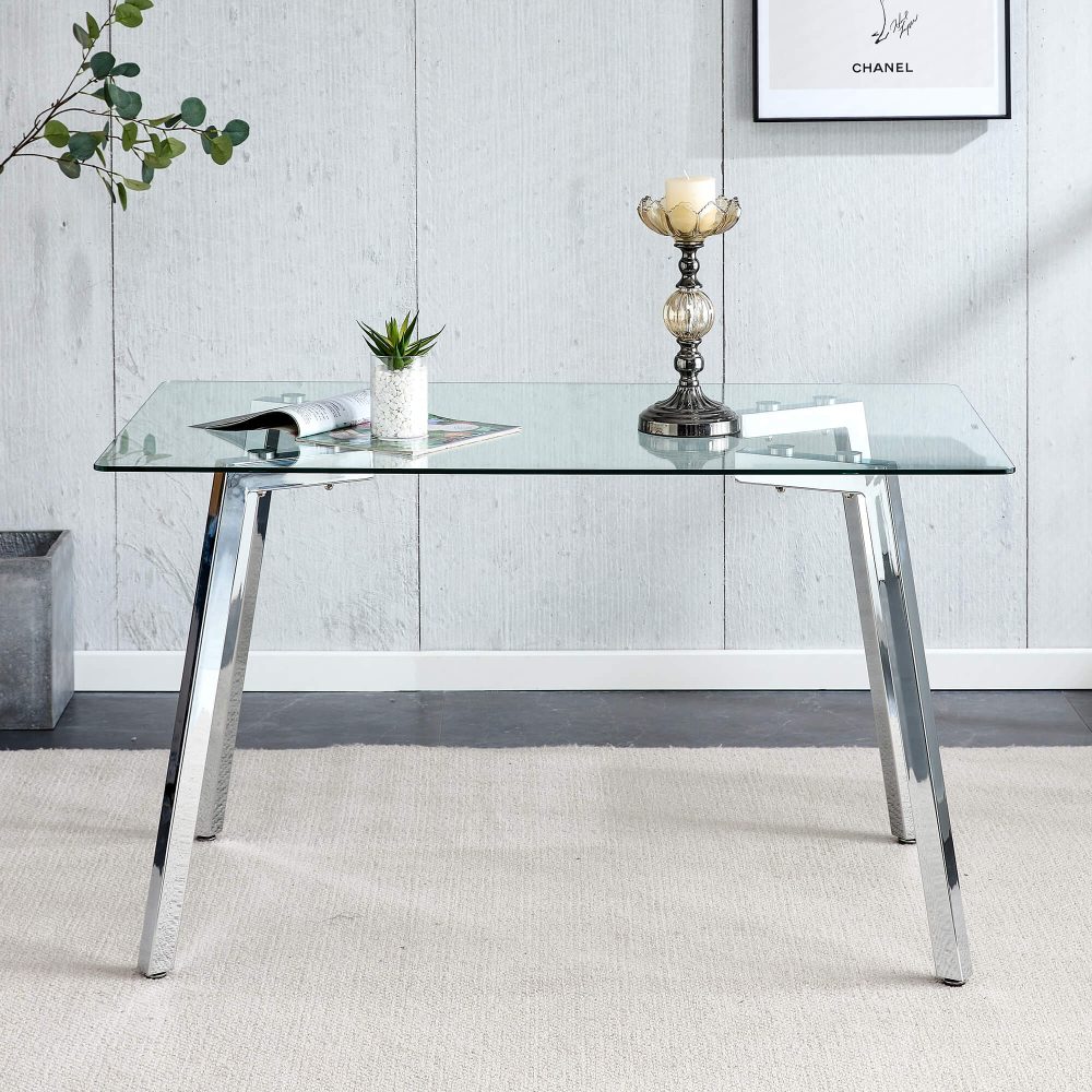 Clear glass dining table with silver carbon steel legs and clean lines