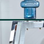 Contemporary glass dining table with transparent top and geometric metal legs