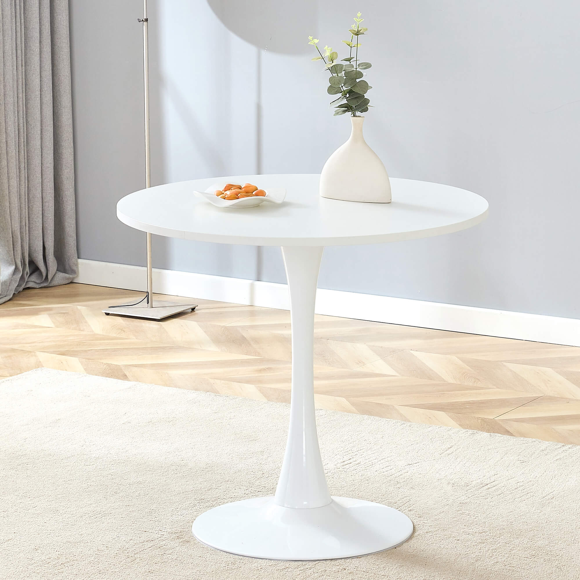 Minimal white pedestal table with smooth surface and modern silhouette Minimal white pedestal table with smooth surface and modern silhouette