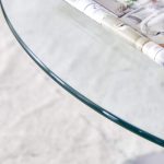 Round glass tabletop table with polished chrome pedestal base