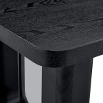 Sleek black dining table with wood texture surface and glass detail