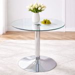 Transparent glass dining table featuring sleek chrome single-leg base