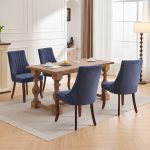 Upholstered dining chair with vertical channel stitching and dark wood legs