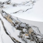 Modern round coffee table styled with decorative accessories and soft sofa