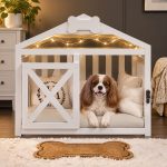 Cute small poodle stepping out of white indoor wooden pet house
