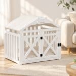 Modern white dog house crate placed beside bed in bedroom