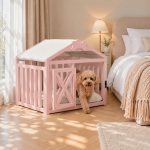 Small poodle walking out of light pink indoor wooden pet crate